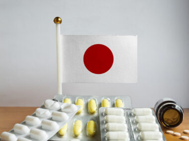 Image of flag of Japan with pills and capsules.